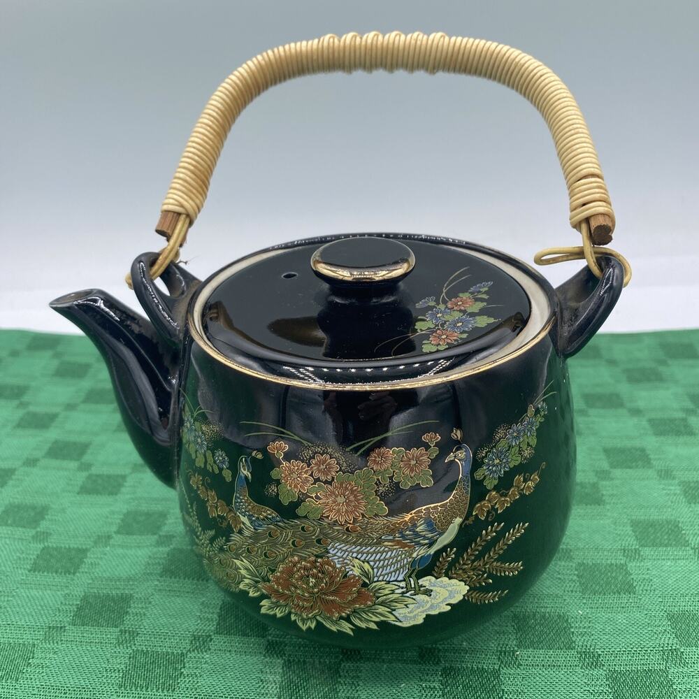 Oriental Style Brown Teapot With A Beautifully Etched Floral And Peacock Design